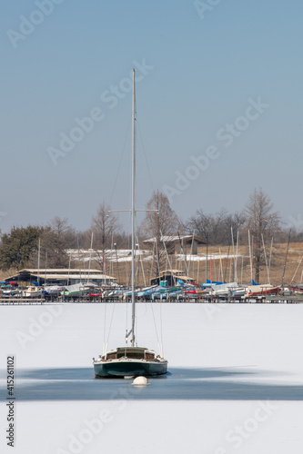 A scene of White Rock Lake in Dallas Texas with sailboats in view after a hard freeze and snow storm in February 2021