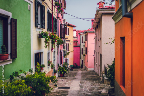 Fototapeta Naklejka Na Ścianę i Meble -  colorful tiny houses in alley bright colourful street slovenia mediteranean