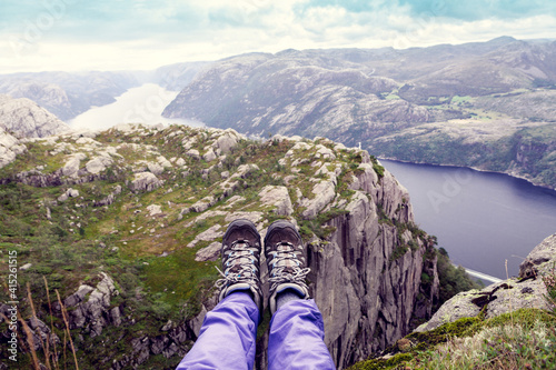 top view of the Norwegian fjord with tourist's legs