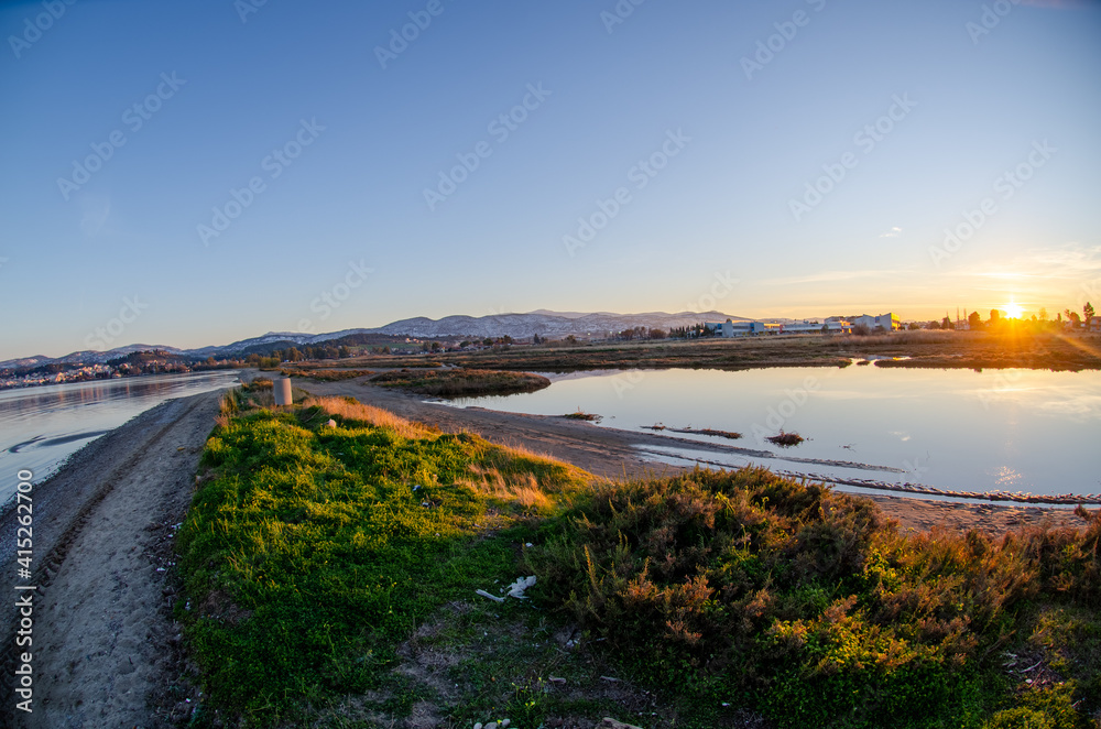sunset over the sea lake oropos greece