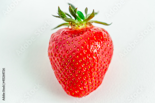 One bright strawberry on a white background  appetizing  beautiful  dietary. Place for text  copy space  flat lay