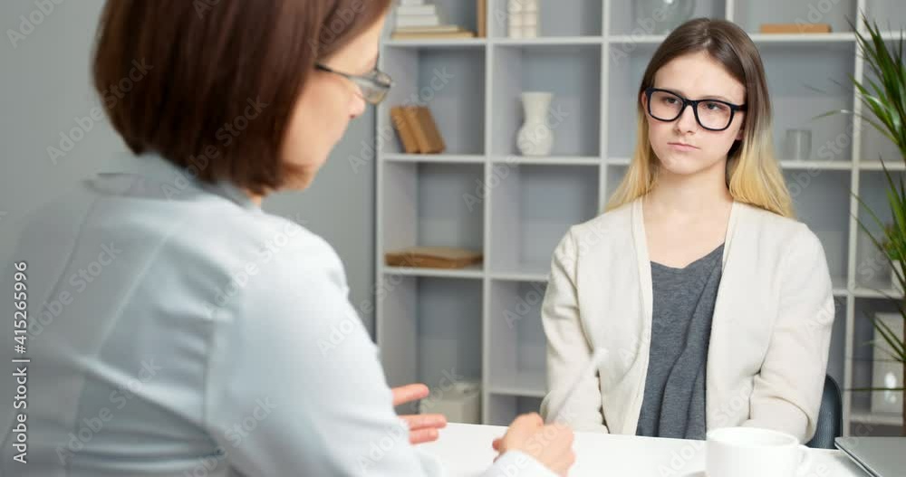 Woman doctor consults a teenage girl in a modern clinic. Woman doctor consults a teenage girl in a modern clinic.
