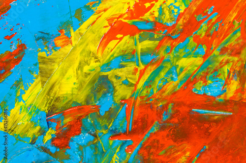 colorful creative motley background: smudged residues of oil paints on a wooden palette, short focus, selective blur