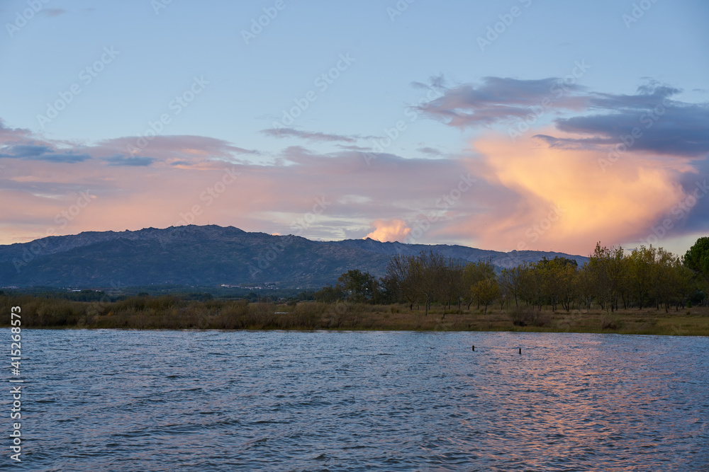 Lake view at sunset with Gardunha mountains on the background at sunset in Castelo Branco, Portugal Lake view at sunset with Gardunha mountains on the background at sunset in Castelo Branco, Portugal