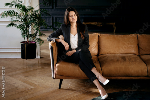 The manager is sitting on the couch. The psychologist is a female student in a business suit of European appearance. Modern and stylish office. Illuminated by sunlight.  © muse studio
