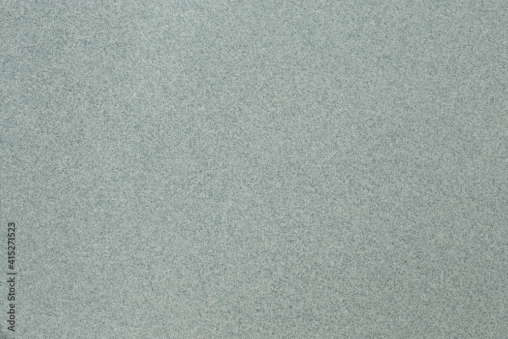A macro shot of a primarily cool toned green background with gray and white speckling. A macro shot of a primarily cool toned green background with gray and white speckling.