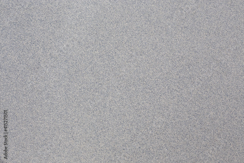 An abstract gray background with blue speckled undertones. 