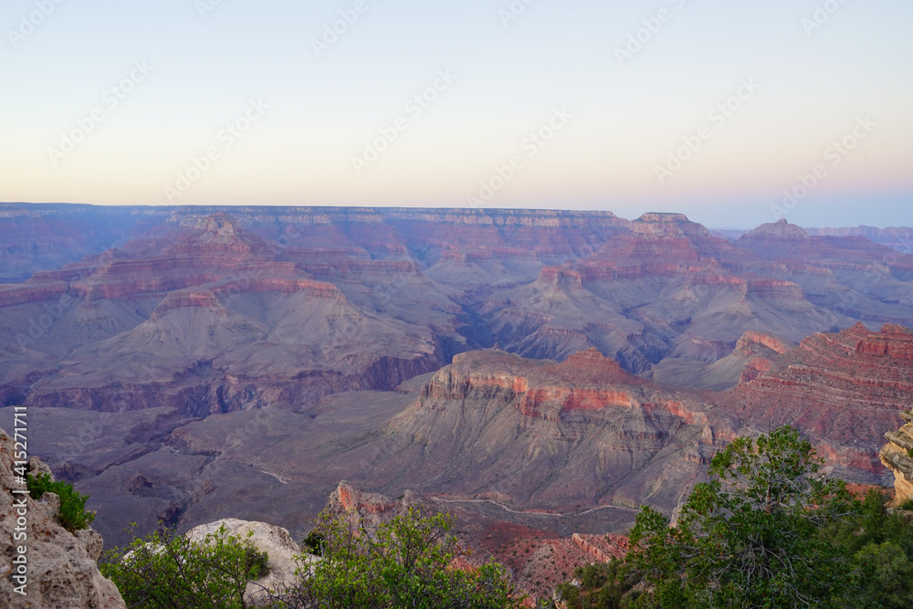 Golden Sunset at Grand Canyon Arizona. Blue smoky haze accentuates the canyon