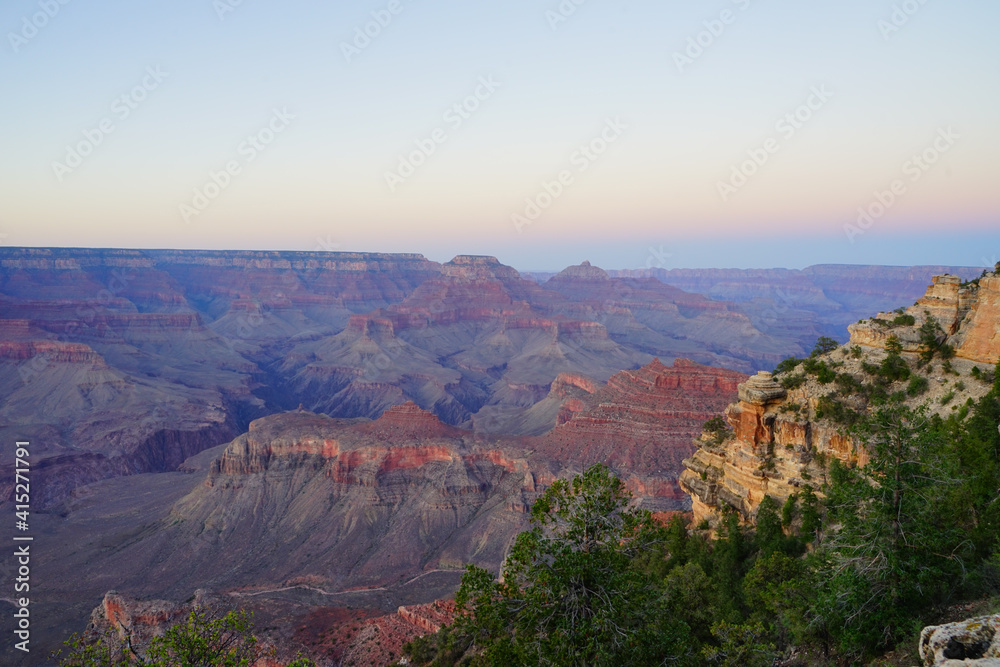 Golden Sunset at Grand Canyon Arizona. Blue smoky haze accentuates the canyon