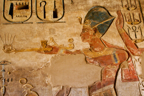 Painted reliefs inside room at Medinat Habu Temple, Luxor, Egypt