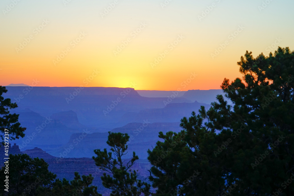 Golden Sunset at Grand Canyon Arizona. Blue smoky haze accentuates the canyon