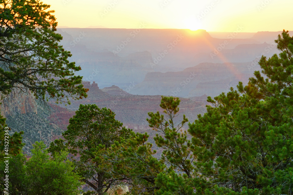 Obraz premium Golden Sunset at Grand Canyon Arizona. Blue smoky haze accentuates the canyon