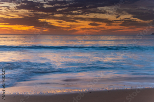 Pretty blue summer sunrise seascape with high cloud © Merrillie