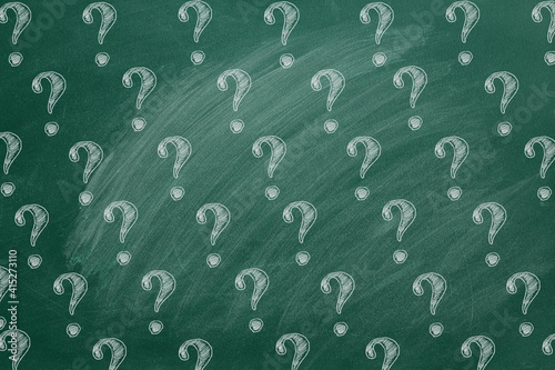 Question marks on blackboard. Ask for help. FAQ concept.  Asking questions.