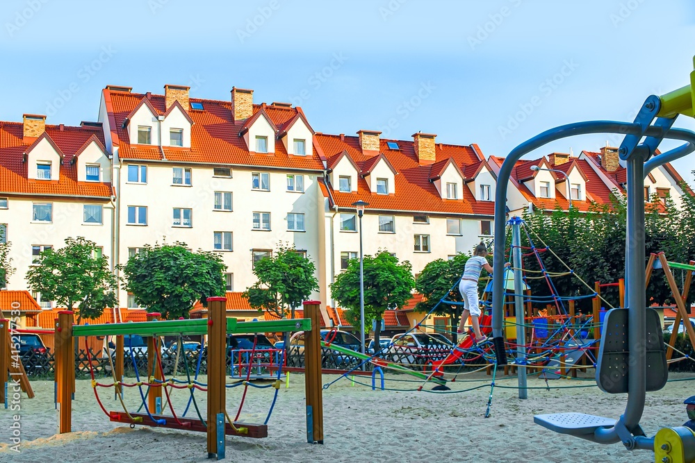 Fototapeta premium New apartment building and children's play complex in the courtyard
