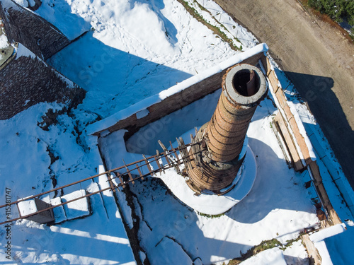 Aerial photo of chimney of an old abandoned factory  during the Medea snowstorm in Athens, Galatsi photo