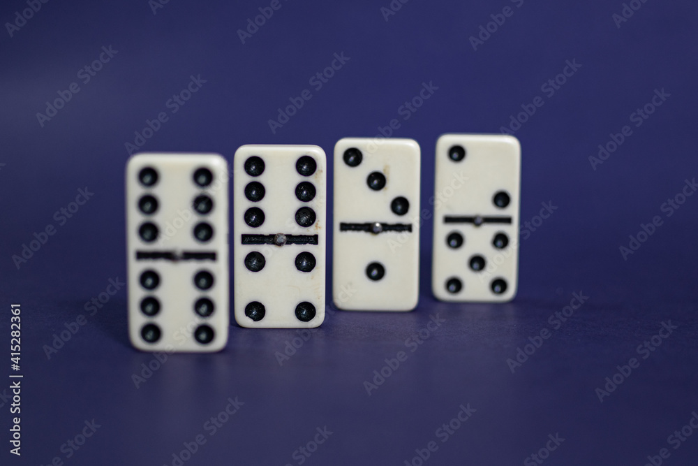 Old fashioned dirty domino stands on a solid backround
Old fashioned dirty domino stands on a solid backround
