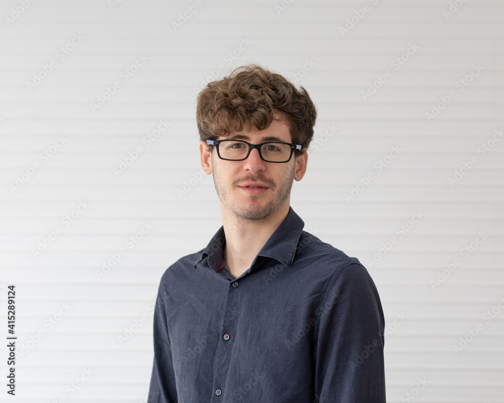 Portrait of man wearing eyeglasses standing with self-confident and friendly looking Portrait of man wearing eyeglasses standing with self-confident and friendly looking