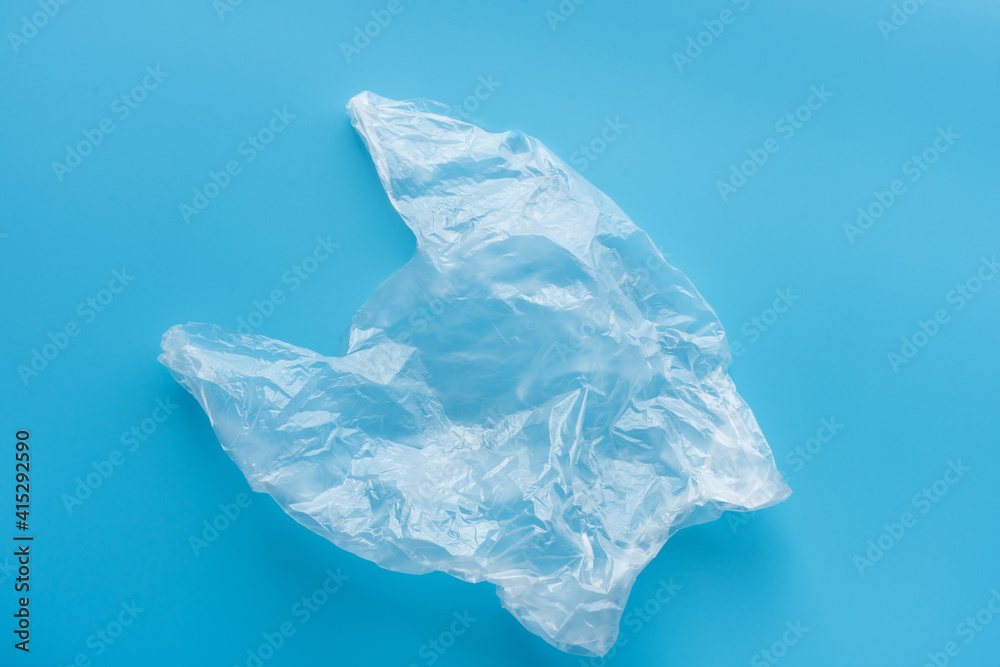 Fototapeta premium Clear plastic bag on blue background,environment concept.