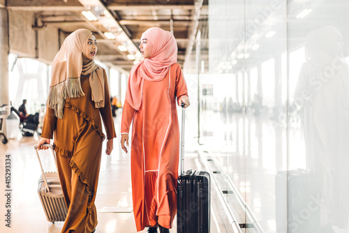 Two young asian muslim woman enjoying shopping and having fun talking together in the shop at fashion store