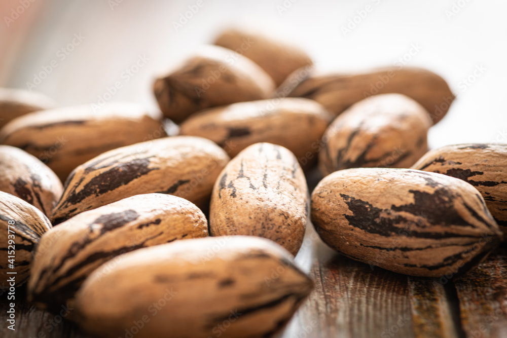 Pecan Nuts In Shell On Wood Table Pecan Nuts In Shell On Wood Table