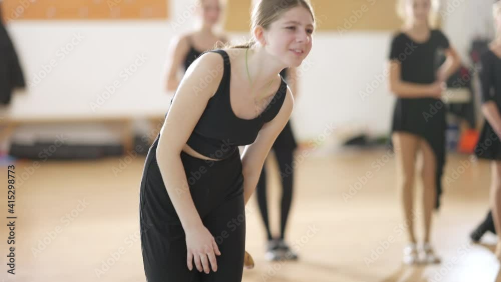 Female ballet dancer suffering ankle pain dancing in slow motion indoors. Portrait of Caucasian girl practicing ballroom dance in dancing school. Art and ache. Female ballet dancer suffering ankle pain dancing in slow motion indoors. Portrait of Caucasian girl practicing ballroom dance in dancing school. Art and ache.