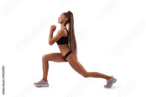 Smiling fit woman in underwear doing sport exercise in studio © Wisky