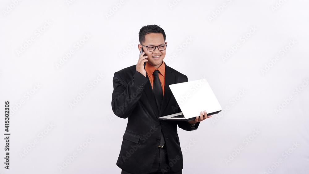 businessman holding a laptop computer while on the phone isolated white background businessman holding a laptop computer while on the phone isolated white background
