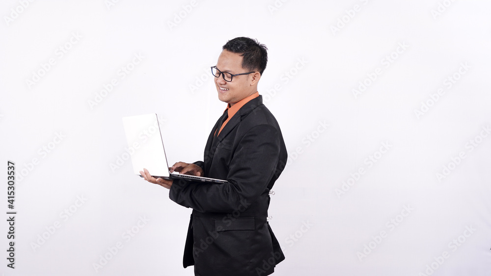 businessman in a suit holding a laptop computer and looking at the camera isolated on white background