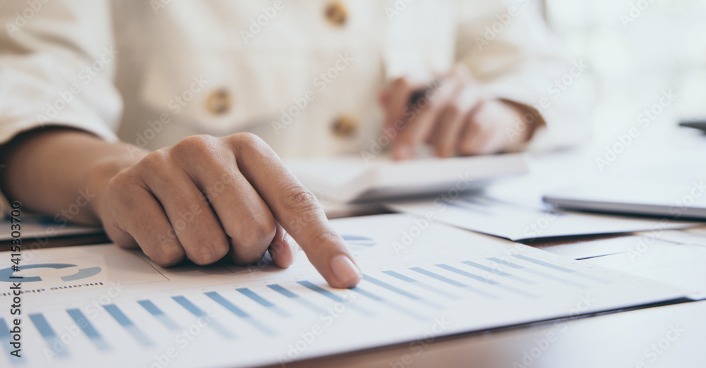 Financial businesswomen analyze the graph of the company's performance to create profits and growth, Market research reports and income statistics, Financial and Accounting concept. Financial businesswomen analyze the graph of the company's performance to create profits and growth, Market research reports and income statistics, Financial and Accounting concept.