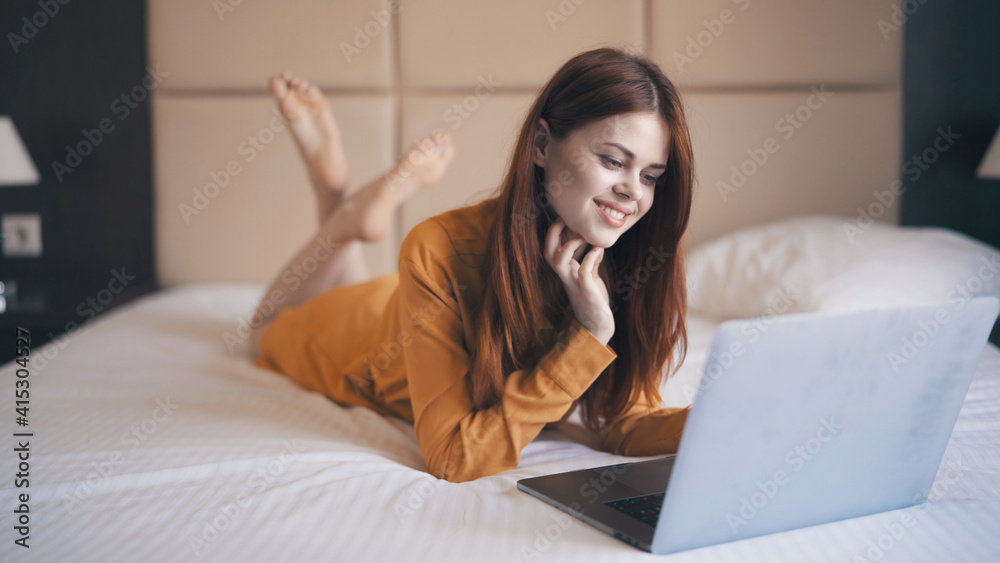 woman with laptop lies on bed internet communication freelance woman with laptop lies on bed internet communication freelance