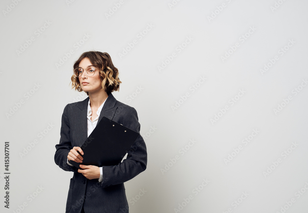 Business woman with documents in hands on a light background indoors Business woman with documents in hands on a light background indoors