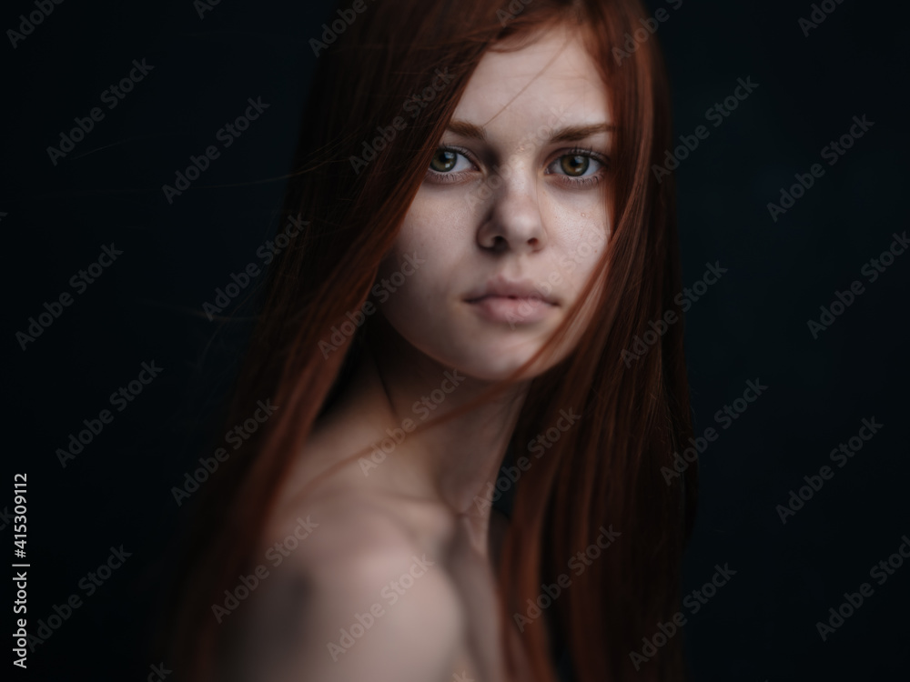 Romantic red-haired woman portrait close-up naked shoulders cropped view