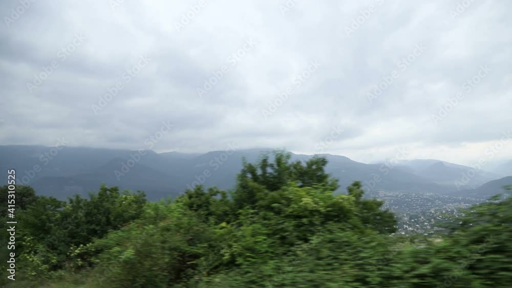 Scenic view Panorama of a village or small town with houses in the middle of green mountains. Scenic view Panorama of a village or small town with houses in the middle of green mountains.