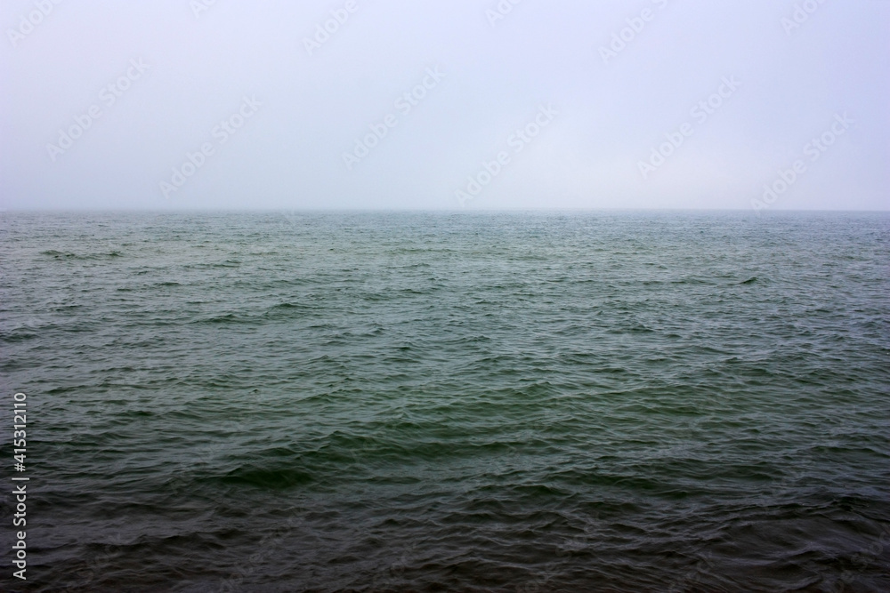 Dark green sea surface in fog