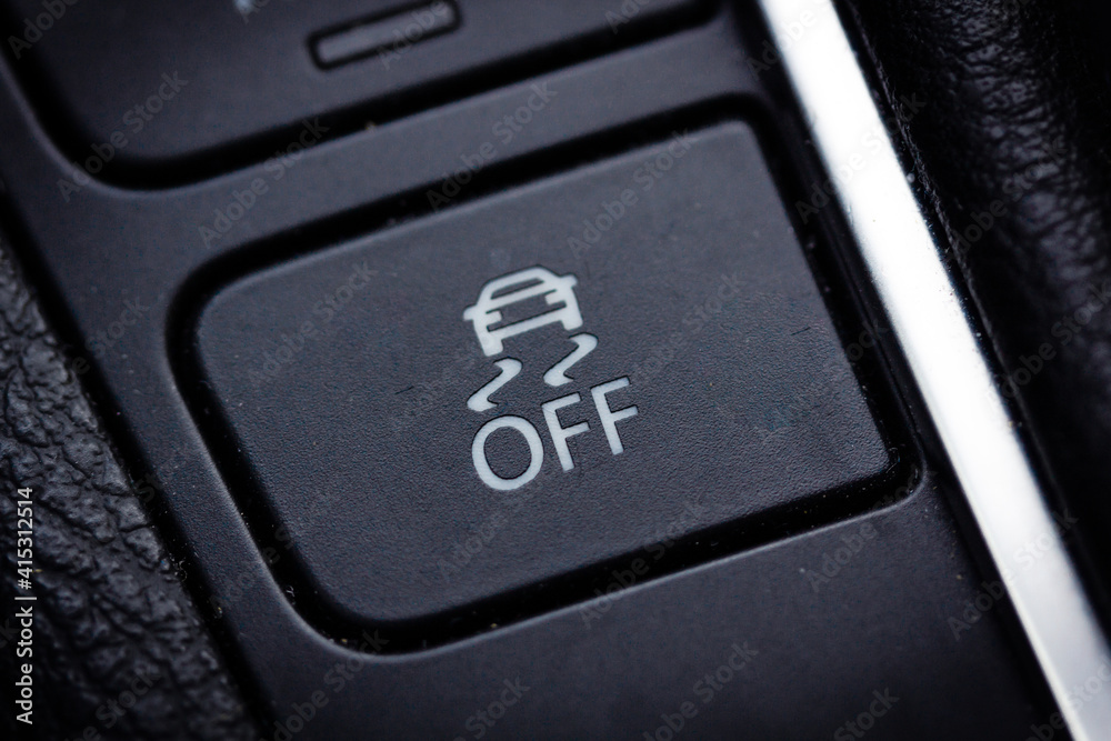 An image of a button for traction control in a modern car. Stock Photo Adobe Stock