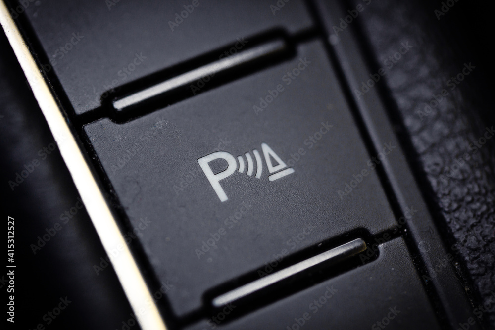 Button for parking sensors on a modern car. Button for parking sensors on a modern car.