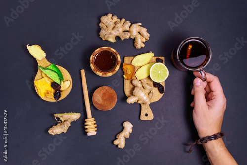 Lime, ginger, Honey Cup of Herbal Tea. Flat Lay. Alternative cold and flu remedy. Healthy Food. on dark background