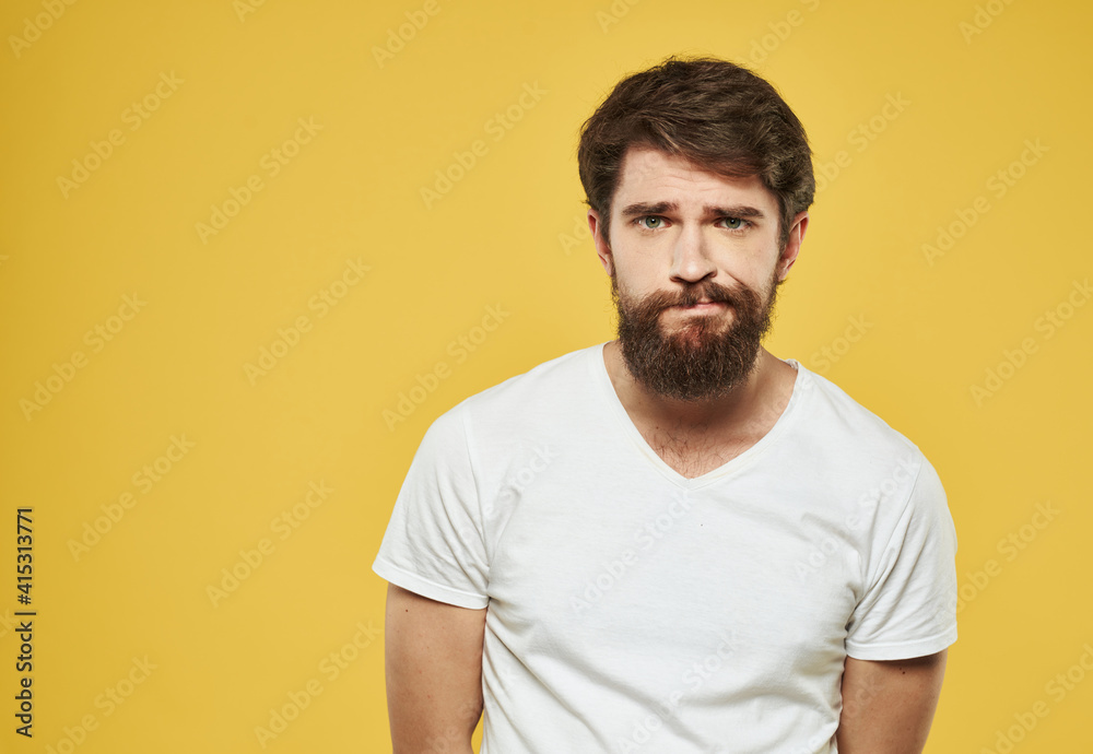 Portrait of handsome man yellow background beard brunette model Portrait of handsome man yellow background beard brunette model