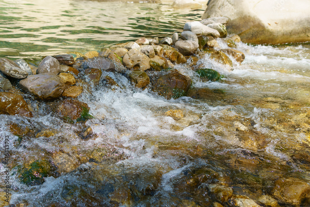 Wild Mountain River Close Up Abundant Clear Stream. Stone Boulders Flowing.