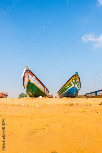 Fishing boats on sandy marina in Chennai Tamil Nadu India