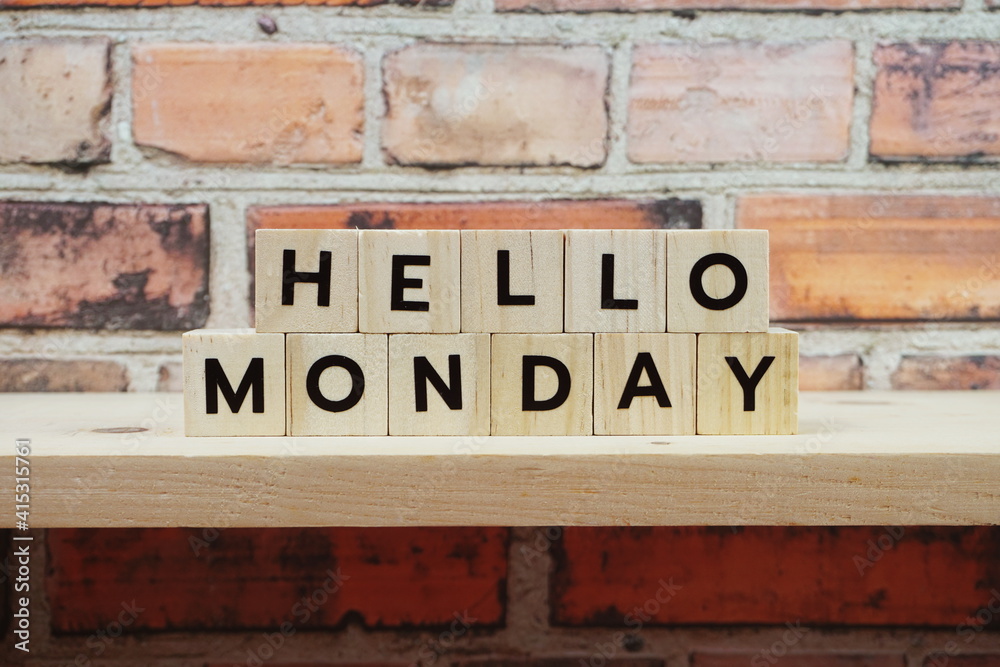 Fototapeta premium Hello Monday alphabet letter on shelves wooden background