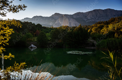 beautiful sunset on a mountain lake, suummer season photo