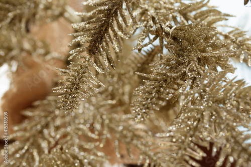 Tiny silvery Christmas decorative tree, close-up with selective focus. Background with copy space