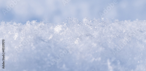 Background of fresh snow. Natural winter background. Snow texture in blue tone.