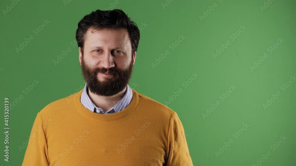 Man holding number 39 sign. Cheerful white bearded good-looking man in yellow sweater shows number thirty-nine on white sheet. Chrome key, green screen, copy space Man holding number 39 sign. Cheerful white bearded good-looking man in yellow sweater shows number thirty-nine on white sheet. Chrome key, green screen, copy space