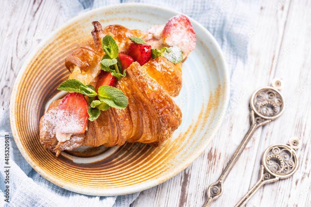 Fresh french croissant with strawberry. Freshly baked croissant. Fresh french croissant with strawberry. Freshly baked croissant.