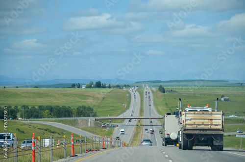 POV to the canadian highway road in British columbia, Canada in summer day with local area on sideway
