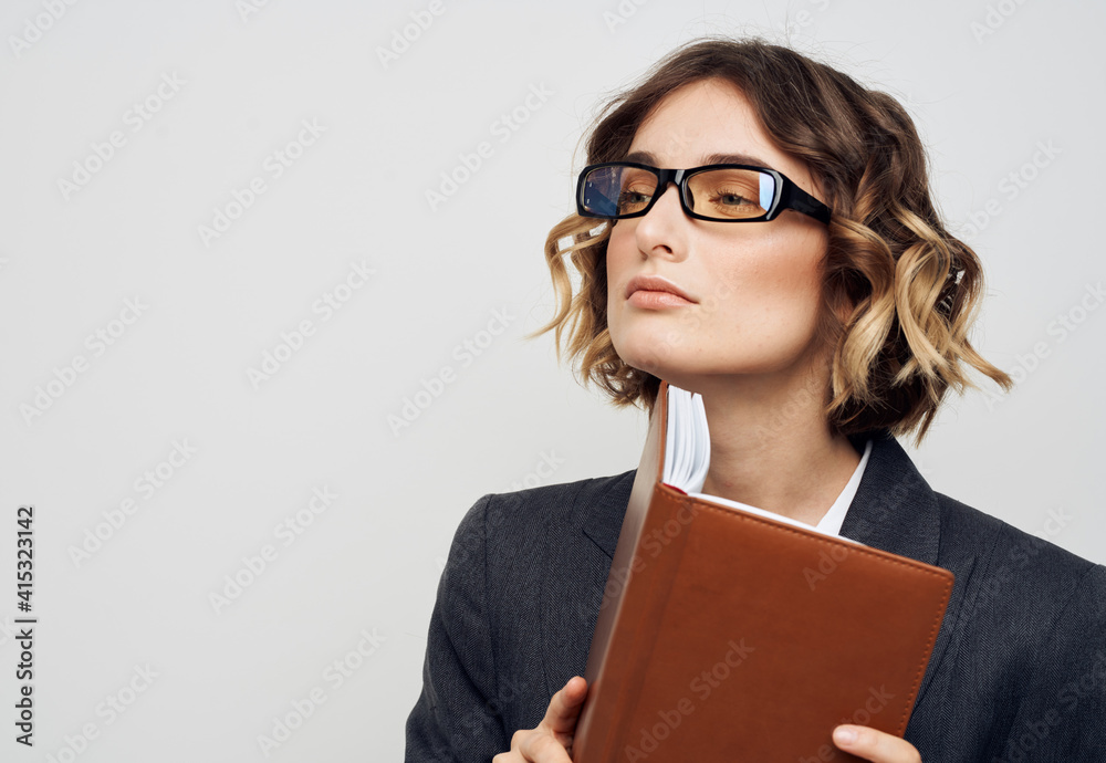 Business woman in classic suit brown book cropped view Business woman in classic suit brown book cropped view