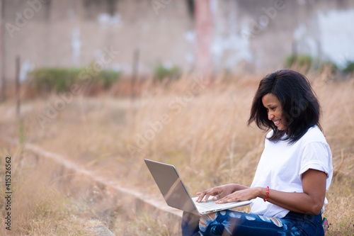 young woman using a laptop outdoor